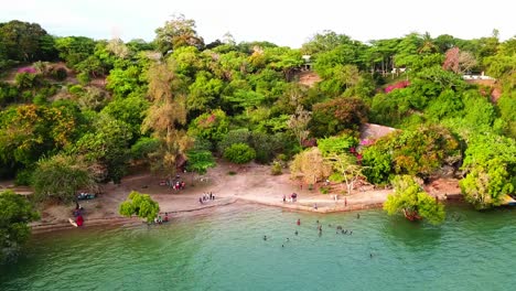 People-Swimming-In-The-Kifili-Creek-In-Kenya-With-Wooden-Dhow-Boat