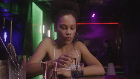 beautiful girl sitting at bar counter while man coming and sitting next to her