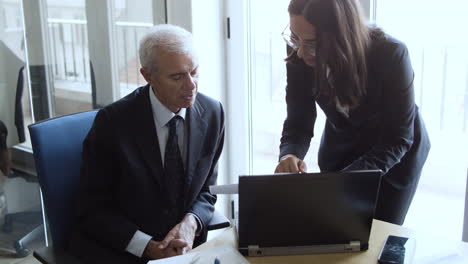 female project manager explaining report details to businessman