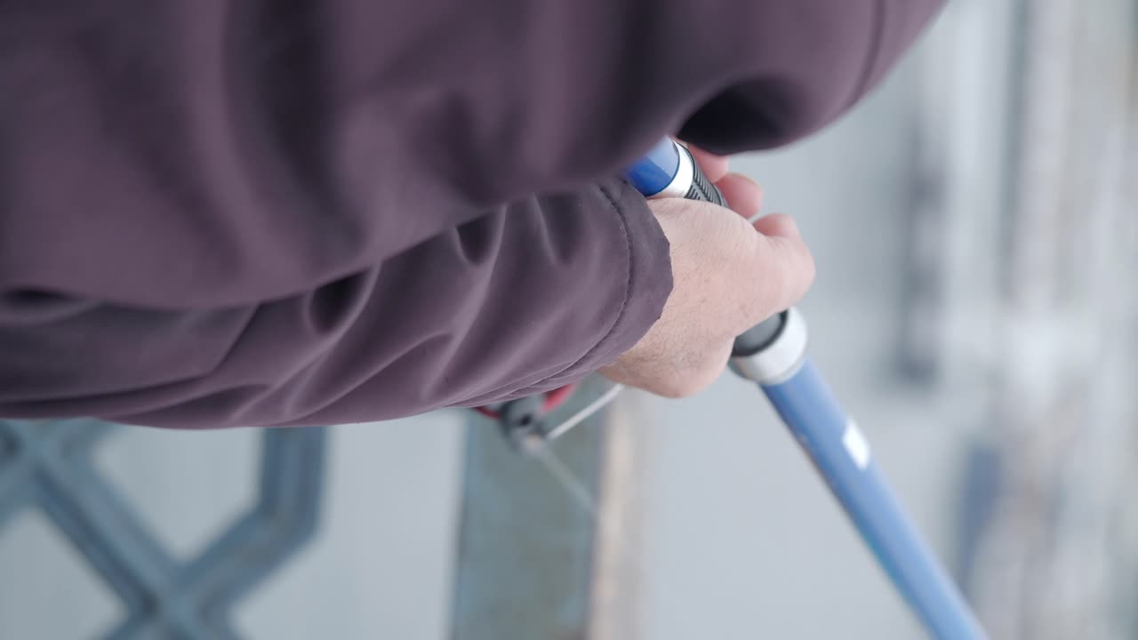 Close Up of Fisherman's Hands Reeling a Fishing Rod