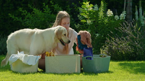 woman doing laundry outdoors with her dog