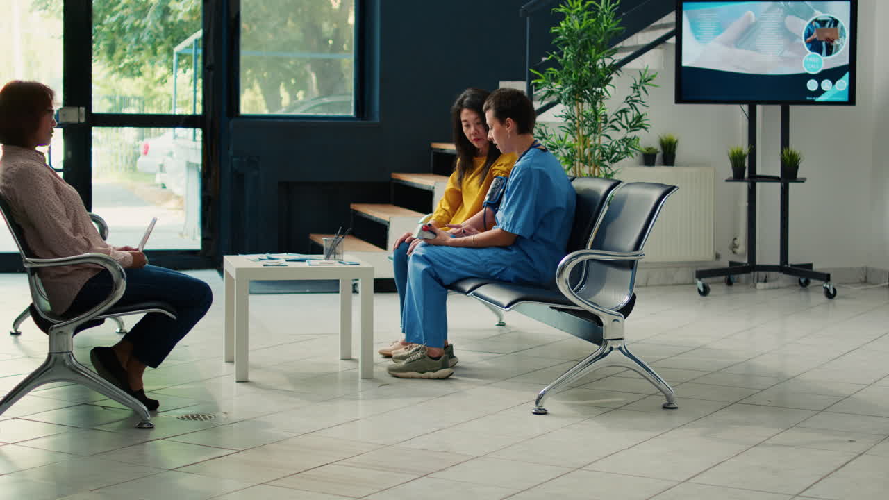 Healthcare professional examining patient's blood pressure in waiting room