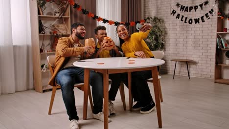 happy family celebrating halloween and carving pumpkins