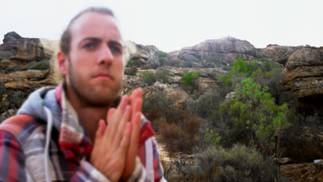 man shaking his hand on top of mountain 4k