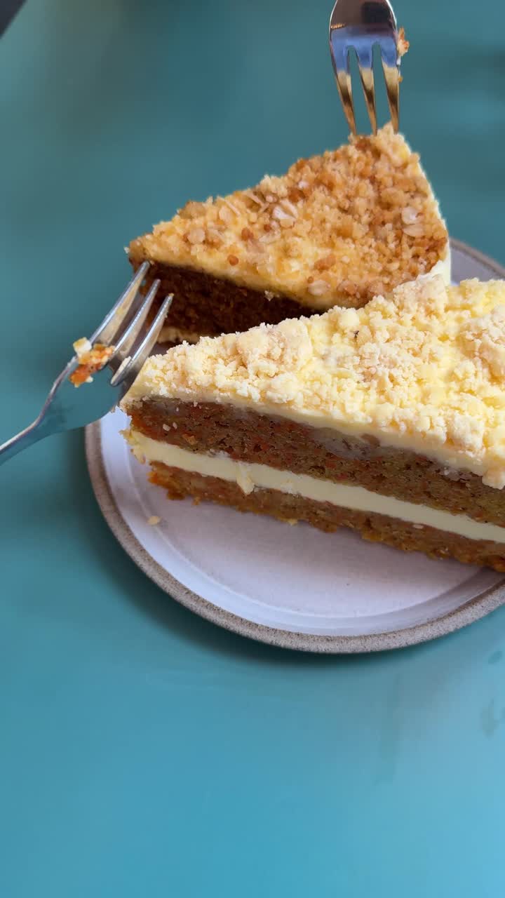 Influencer eating cake. Vertical shot of people taking bites of layered crumb cake with creamy frosting, fork lifting a piece from a slice on a plate dessert food blogger, cafe influencer content
