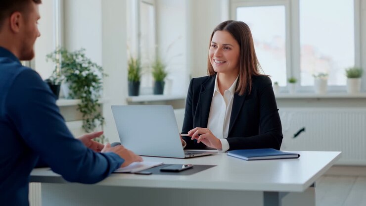 Professional Interview Scene White Woman Smiling While Discussing Job Details With White Male Candidate