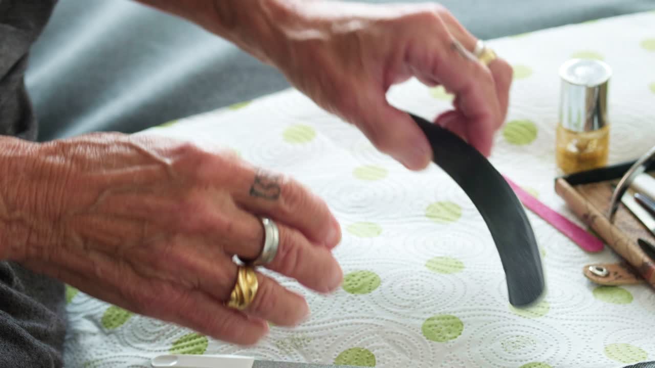 older lady woman hands during a manicure session. Highlighting skin texture and the process of nail maintenance as part of a healthy aging and wellness routine