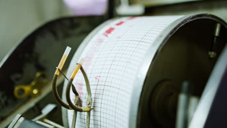 male hand touching the roll of a seismographic equipment. close up. technical appliances used for oil and gas drilling.