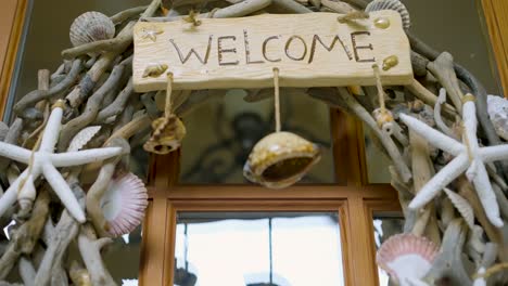 a beautiful welcome decor on the front of a house made out of seashells