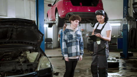 mechanic talking with client