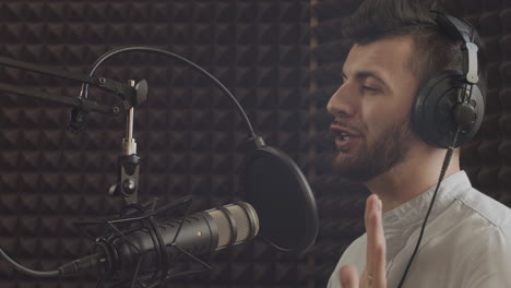 el presentador de radio joven y barbudo con llaves se despide de sus oyentes y se quita los auriculares