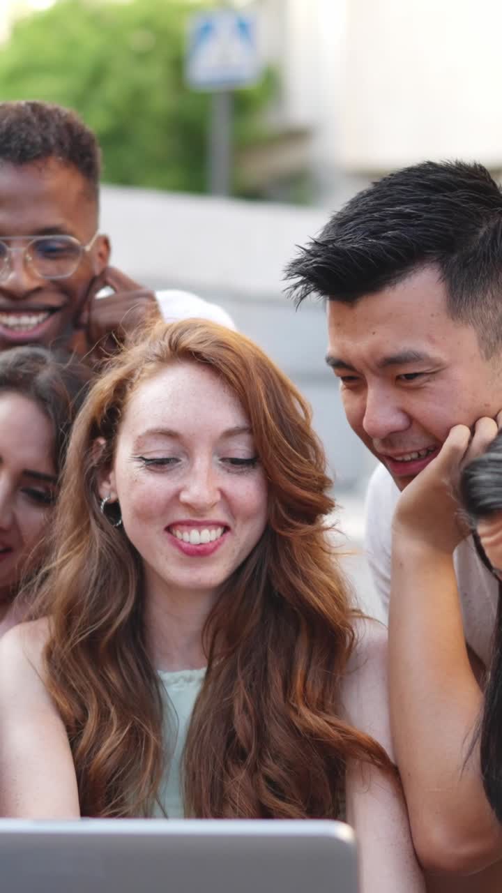 Happy Diverse Group of Friends Looking at a Screen Together