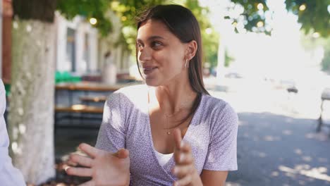 young woman in conversation outdoors