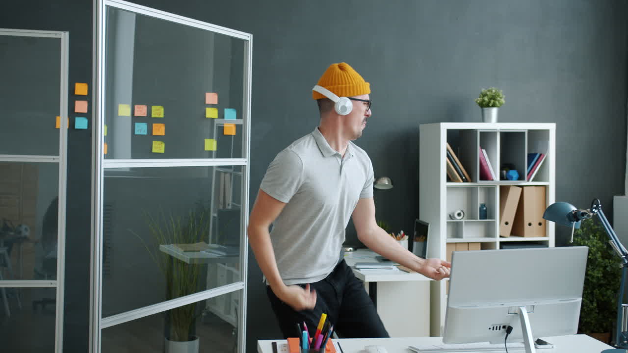 Man Dancing in Office While Listening to Music