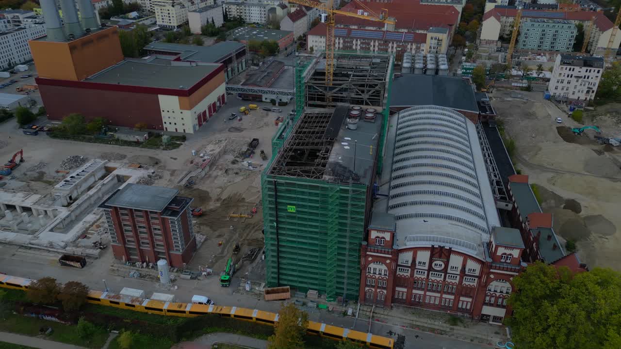 converted cogeneration Power plant , industrial buildings, and a large urban construction site. Spectacular aerial view flight drone camera pointing down