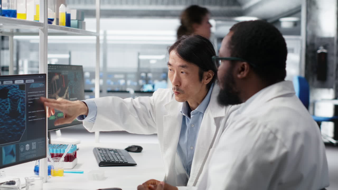 Multiracial Engineers Using Scientific Gear In Research Facility