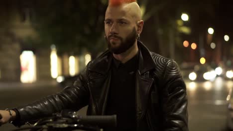 close up footage of handsome rider sitting in leather jacket on motocycle on the city night street