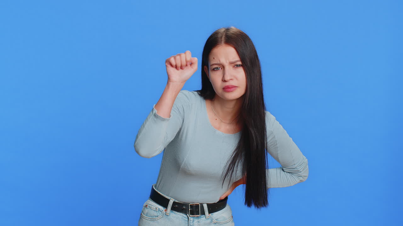 Excited young woman knocking door gesture asking who is at home feeling embarrassed no idea