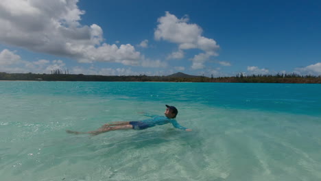 woman floating relaxed in turquoise tropical waters