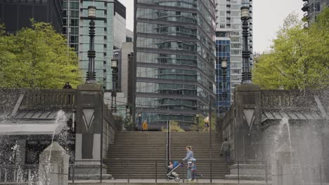 people walking near fountain in harbour green park, skyscrapers in background, downtown vancouver, british columbia, canada