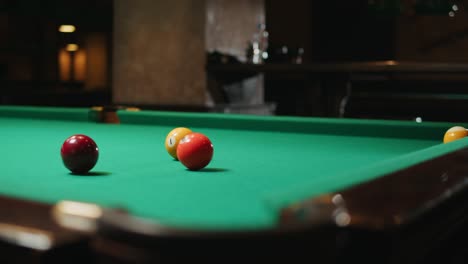 playing american billiard poule close-up. colorful balls on green billiards table .billiard balls with numbers on a pool table. billiards team sport. high quality 4k footage