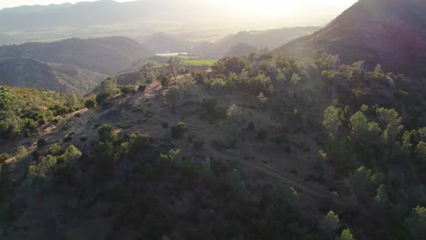 Aerial-pullback-on-vibrant-sunset-to-reveal-mountain-side-in-the-Napa-Valley