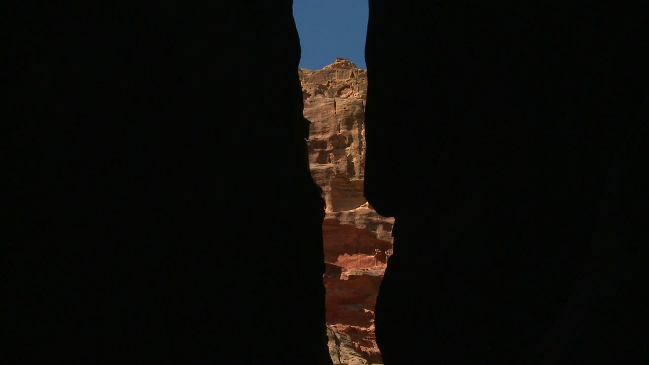 View of the facade of the Treasury building in the ancient Nabatean ruins of Petra Jordan through the narrow canyon entrance 1