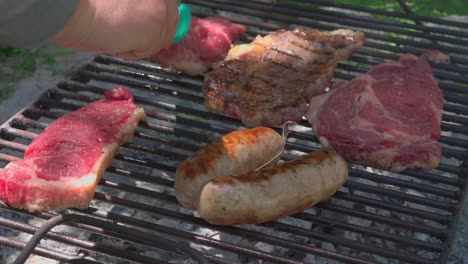 argentinian barbecue, tradicional asado. turning the steaks over