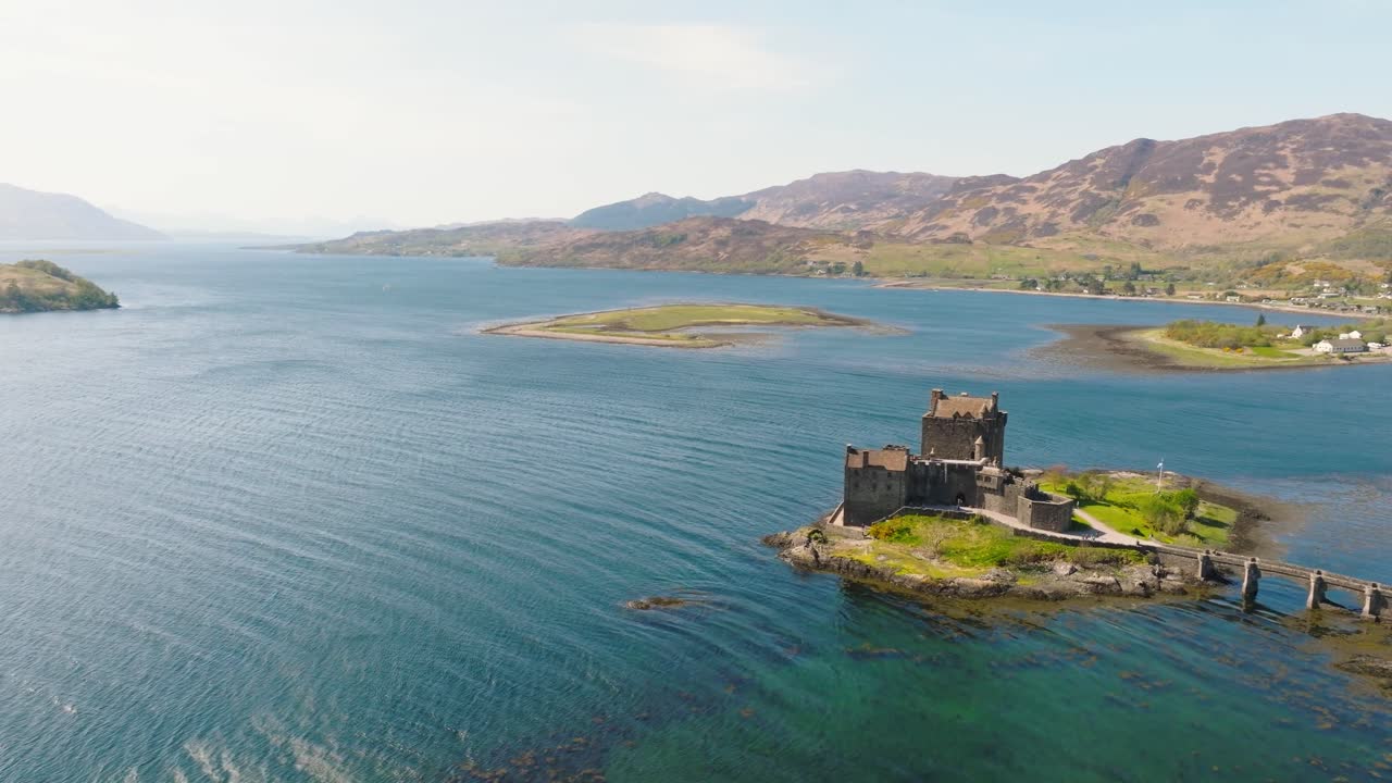 Aerial drone footage of Eilean Donan Castle, one of Scotland’s most iconic landmarks, located on a small tidal island