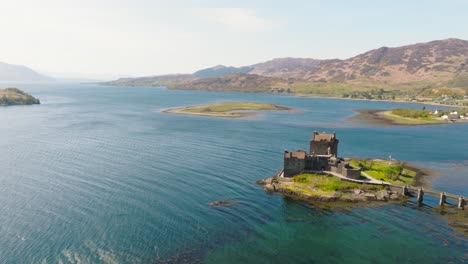 aerial drone footage of eilean donan castle, one of scotland’s most iconic landmarks, located on a small tidal island