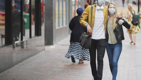 front view of caucasian couple on the go wearing coronavirus covid19 mask