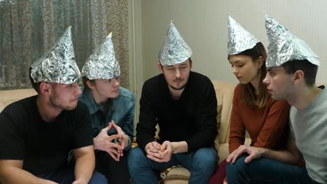 friends wearing foil hats having a conversation