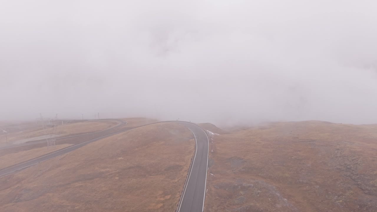 Stelvio Pass from above with autumn colors and low clouds, Italy