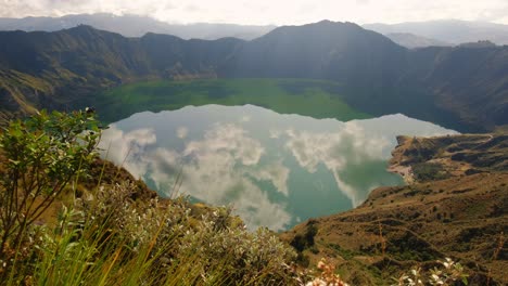 quilotoa lake in ecuador, clouds reflecting in water