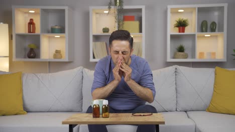 man covering mouth and nose while sneezing.