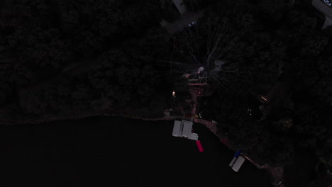 drone flying over large mortar fireworks being shot over a lake on 4th of july