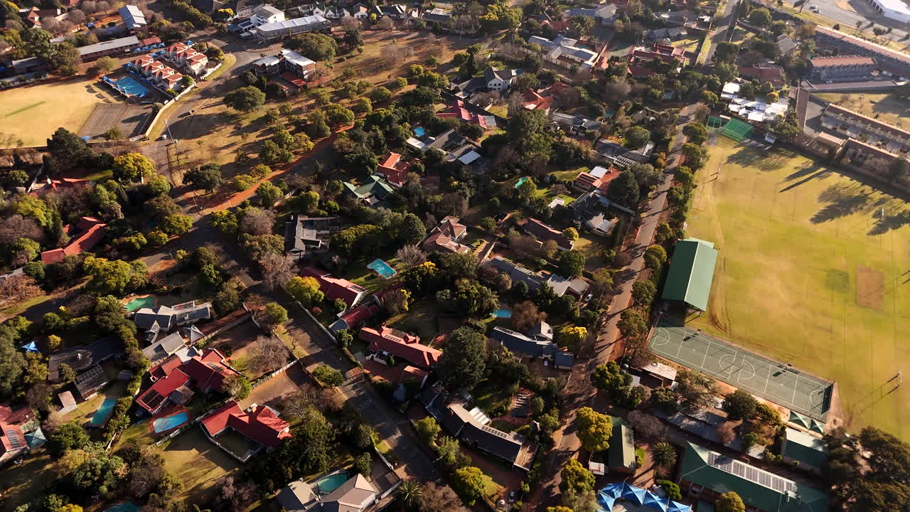 Drone tilt-up over Randburg suburb in Johannesburg next to school grounds