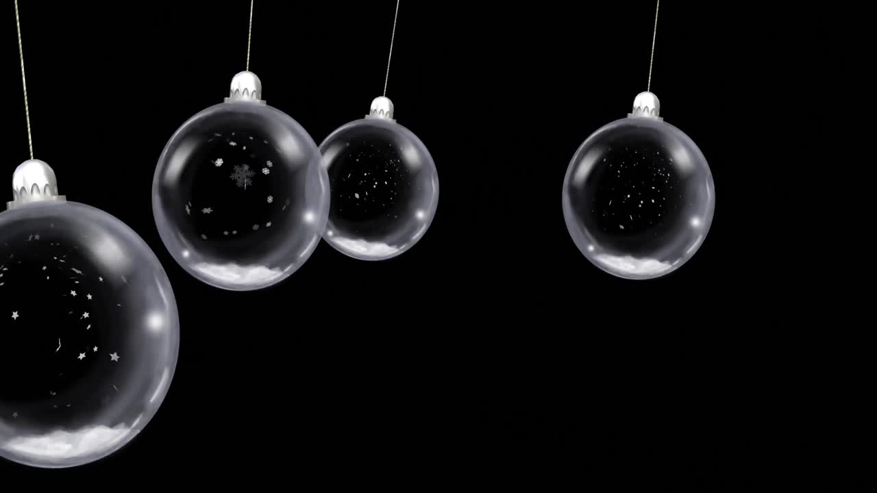 Animation af dinglende julekugler med faldende sne på sort baggrund