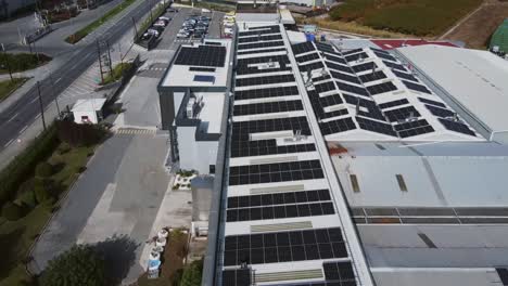 close up flight over solar panels farm installed on a facility complex roof