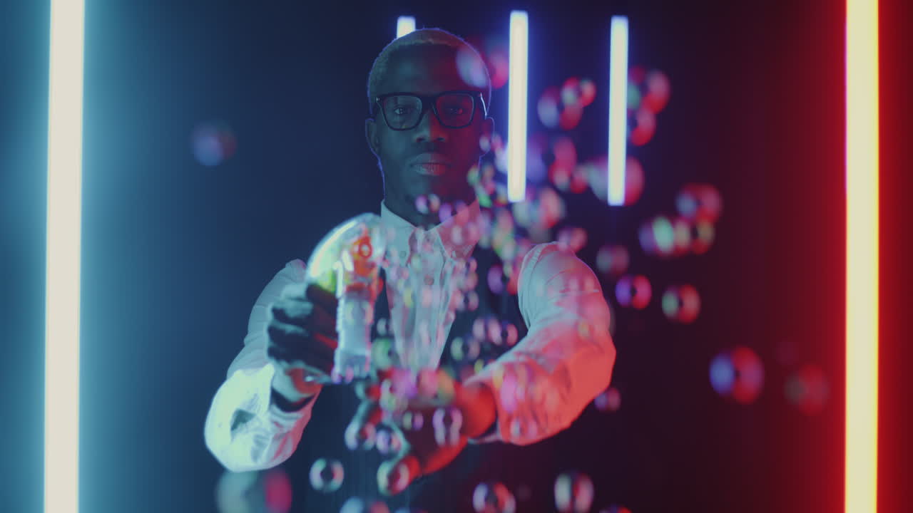 Man Making Bubbles in Neon Light