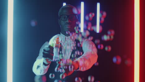 man making bubbles in neon light