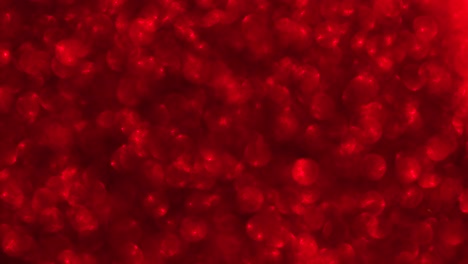 fondo de video 4k de brillo brillante abstracto. fondo de brillo rojo con textura brillante. luz brillante de rubí, chispas de pañuelos y fondo de aluminio brillante.