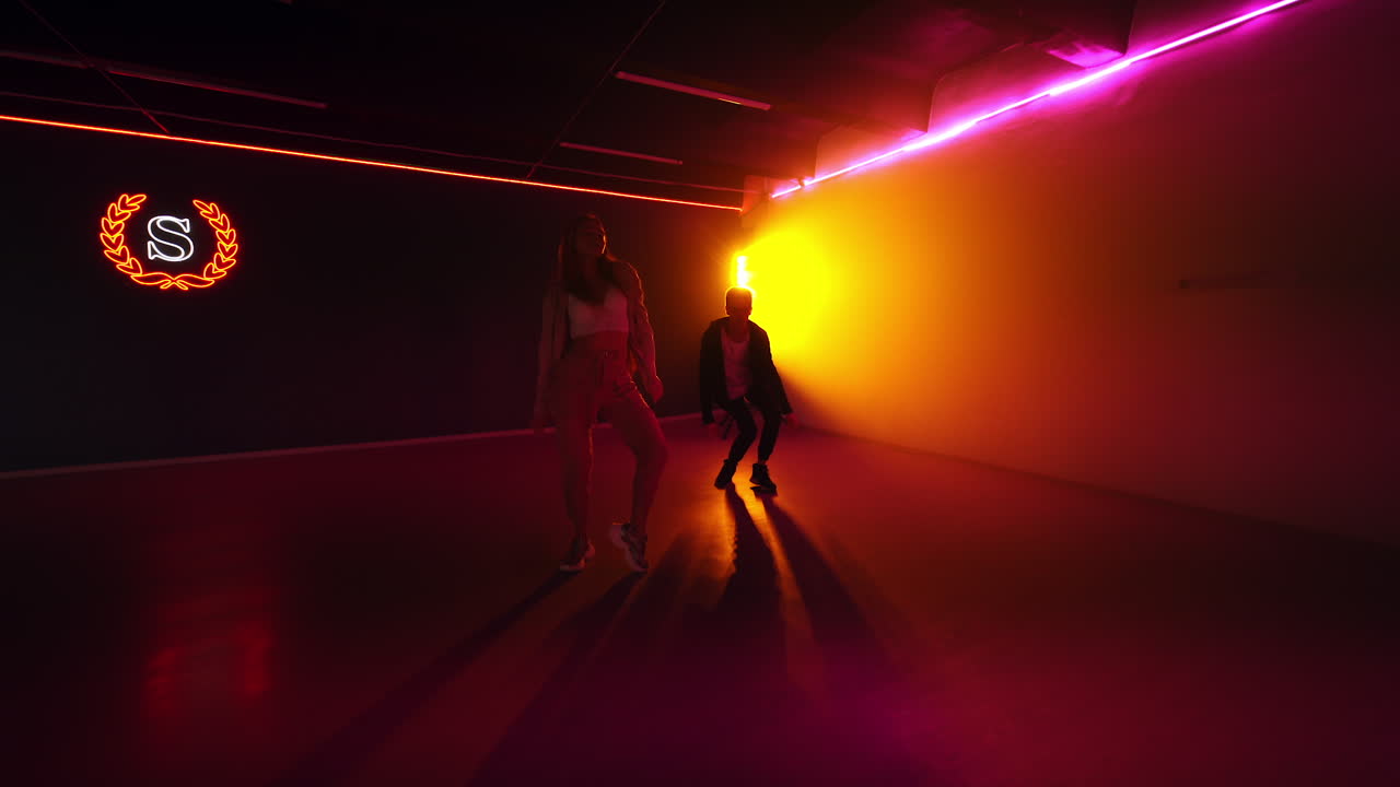 Energetic Dance Performance in Neon-Lit Studio