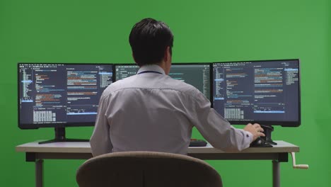 Person Coding on Multiple Monitors