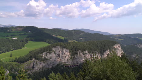 beautiful landscape with rock cliffs, forest and cloudy sky