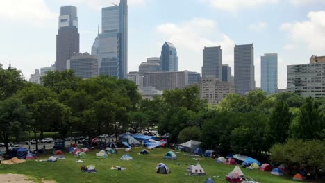 protesters in black lives matter blm camp on public park in urban city, philadelphia, usa, public protest theme, aerial view