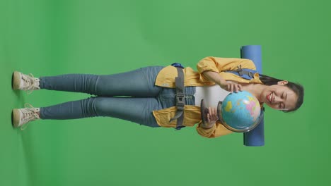 woman with a backpack and globe