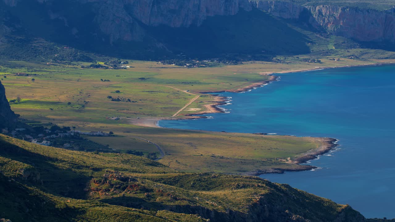 Coastline and grassy plain in san vito lo capo, sicily, italy, static aerial view
