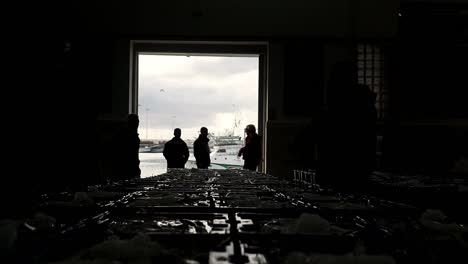 silhouette of fishermen in a fresh fish store