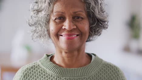 Portrait-of-happy-senior-african-american-woman-looking-at-camera-and-smiling